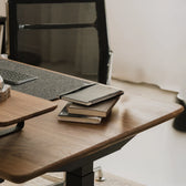Pelicanwork Standing Desk Pro in natural wood, ergonomic office chair in modern workspace